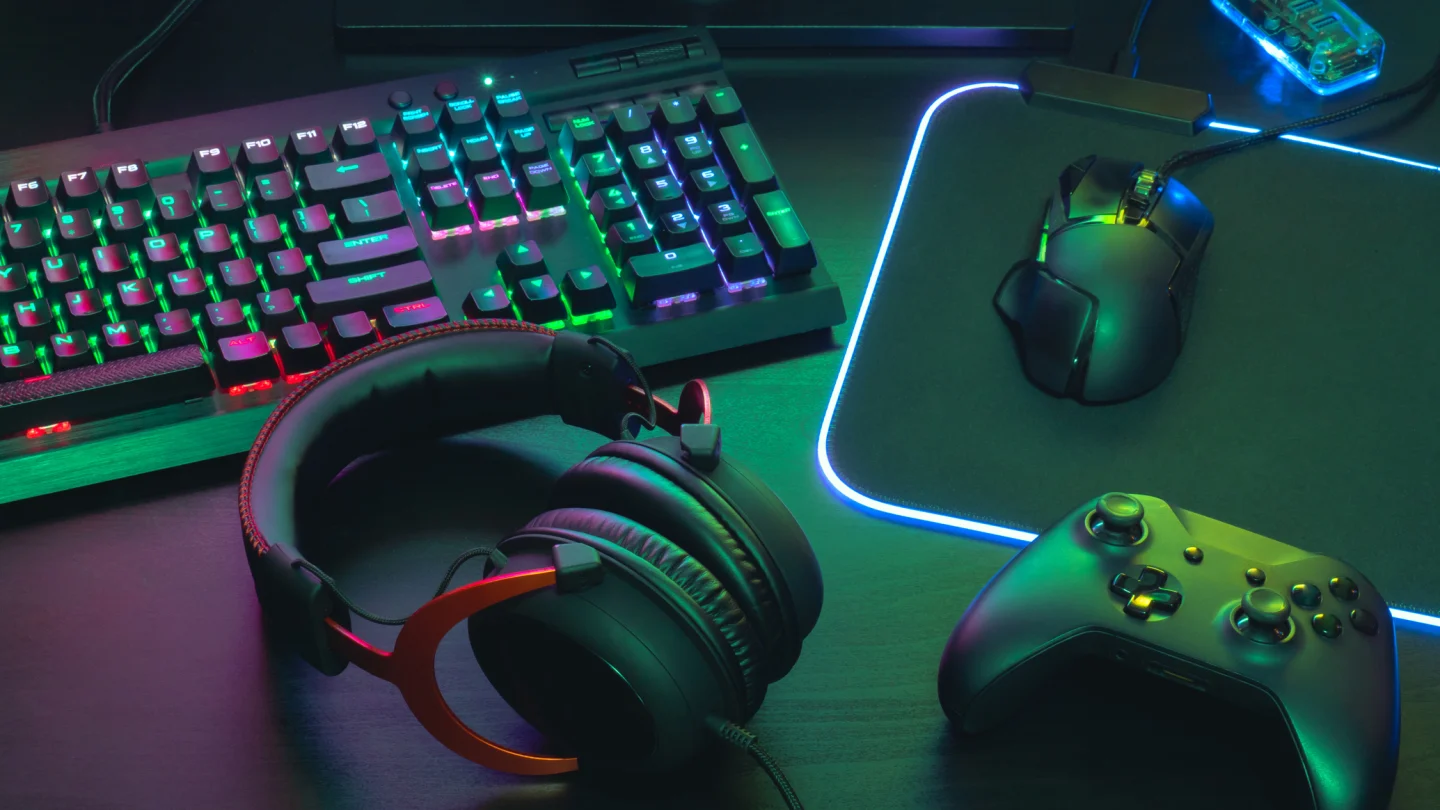 Gaming setup with RGB keyboard, headphones, mouse and controller